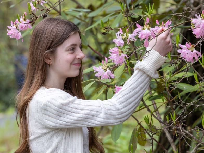 Young girl enjoying pink blooms